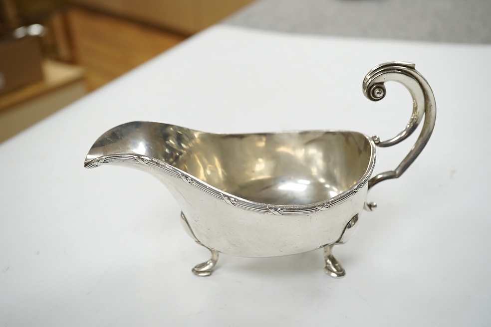 A modern silver sauceboat, 8.4oz and three silver condiments including a pair of pepperettes. Condition - fair